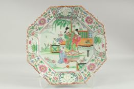 A CHINESE FAMILLE ROSE PORCELAIN OCTAGONAL PLATE, painted with two female figures and a child in