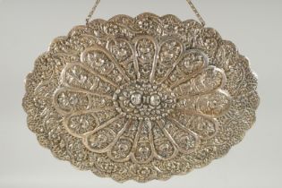 A 19TH CENTURY OTTOMAN EMBOSSED SILVER MIRROR, with relief floral decoration and hanging chain, 30.