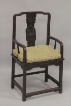 A GOOD 19TH CENTURY CHINESE REDWOOD ARMCHAIR, with curving top rail, carved central splat, solid