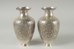 A PAIR OF EARLY 20TH CENTURY SIGNED PERSIAN SILVER VASES, with fine embossed and engraved decoration