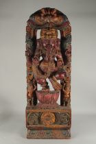 A VERY LARGE 19TH CENTURY INDIAN CARVED WOOD GANESH, the base carved with floral patterns, 107cm