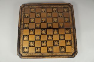 A CHINOSERIE GILDED AND LACQUERED FOLDING CHESS & BACKGAMMON BOARD, 49.5cm square fully opened.