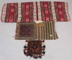 THREE PERSIAN SADDLE BAGS AND RUGS.