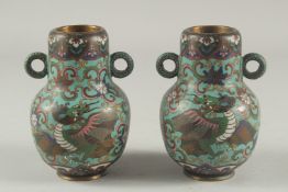 A PAIR OF UNUSUAL CHINESE TURQUOISE GROUND TWIN HANDLE CLOISONNE DRAGON VASES, bases with