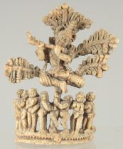 A FINE 17TH-18TH CENTURY SOUTH INDIAN CARVED BONE FLUTING KRISHNA UNDER TREE, 10.5cm high.