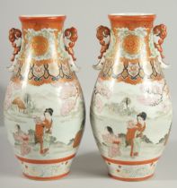 A FINE PAIR OF JAPANESE KUTANI PORCELAIN TWIN HANDLE VASES, painted with a continuous scene