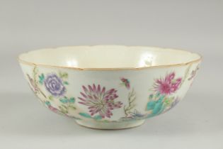 A CHINESE FAMILLE ROSE PORCELAIN BOWL, painted with flora, 22.5cm diameter.