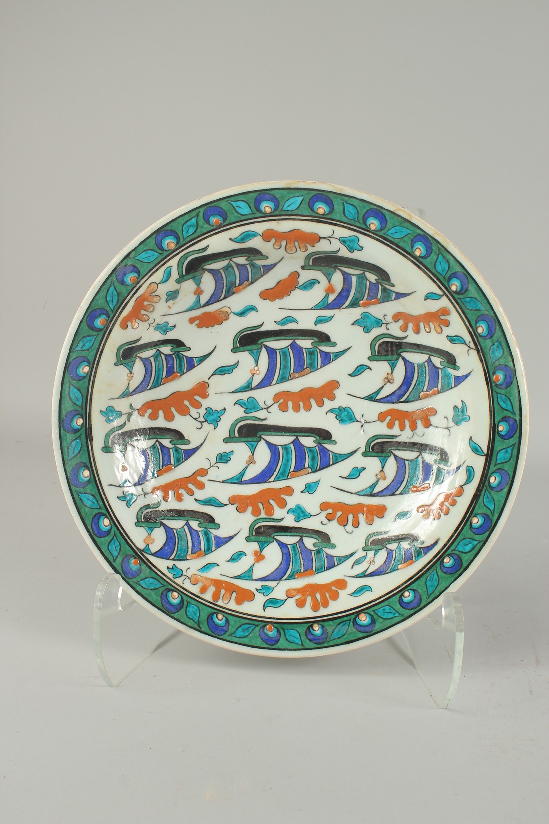 AN OTTOMAN TURKISH IZNIK GLAZED POTTERY PLATE with ships, 31cm diameter.