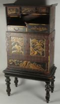 A FINE JAPANESE GILDED AND LACQUERED CABINET ON STAND, hand decorated with panels of birds and