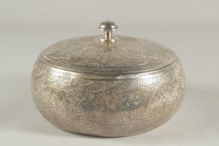 AN ENGRAVED WHITE METAL CIRCULAR LIDDED BOX, 21cm diameter.