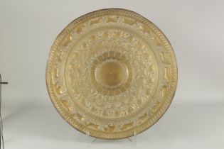 A LARGE LATE 19TH CENTURY SRI LANKAN OR SOUTH INDIAN BRASS TRAY, with bands of embossed and chased