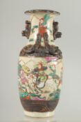 A SMALL CHINESE FAMILLE ROSE GLAZED POTTERY VASE, beautifully painted with figures on horseback, the