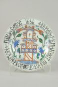 AN OTTOMAN TURKISH GLAZED POTTERY PLATE, with Armenian writing, 31.5cm diameter.