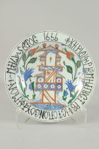 AN OTTOMAN TURKISH GLAZED POTTERY PLATE, with Armenian writing, 31.5cm diameter.