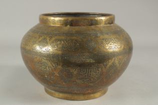 A 19TH CENTURY SYRIAN OR EGYPTIAN ENGRAVED BRAS BOWL, with panels of calligraphy, 26cm diameter.