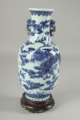 A CHINESE BLUE AND WHITE PORCELAIN TWIN HANDLE DRAGON VASE, on a hardwood stand, the vase with six-