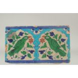 A LARGE EARLY 19TH CENTURY NORTH INDIAN MULTAN GLAZED POTTERY TILE, depicting two birds mihrab