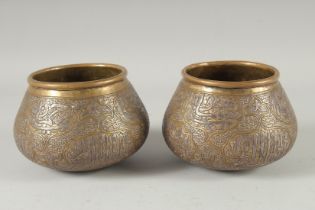 A PAIR OF MAMLUK SILVER INLAID BRASS BOWLS, with calligraphic panels and chased interlocking motif