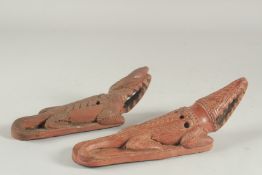 TWO LATE 19TH CENTURY OTTOMAN TURKISH OR EYGPTION RED CLAY FOOT SCRAPERS formed as crocodiles,