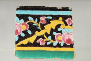 AN 18TH-19TH CENTURY PERSIAN QAJAR GLAZED POTTERY TILE, 9.5cm x 11cm.