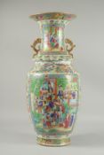 A LARGE CHINESE FAMILLE ROSE PORCELAIN TWIN HANDLE VASE, painted with panels of multiple figures