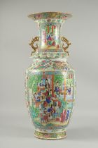 A LARGE CHINESE FAMILLE ROSE PORCELAIN TWIN HANDLE VASE, painted with panels of multiple figures