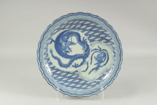 A LARGE CHINESE BLUE AND WHITE PORCELAIN DISH, painted with dragon and phoenix, the dish with