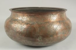 A LARGE 17TH CENTURY TINNED COPPER BASIN, with calligraphy and engraved fish decoration, possibly