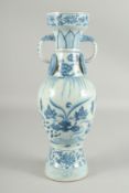 A CHINESE BLUE AND WHITE GLAZED POTTERY TWIN HANDLE VASE, painted with ducks and lotus, 38.5cm