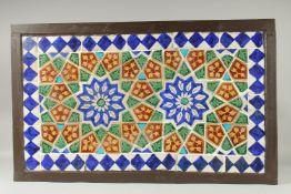 A FINE LARGE 19TH CENTURY INDIAN GLAZED POTTERY TILED PANEL, inset within a wooden frame; possibly a