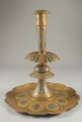 A LARGE 19TH CENTURY PERSIAN QAJAR SILVER INLAID ENAMELLED BRASS CANDLESTICK, 39cm high.