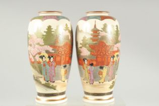 A PAIR OF JAPANESE SATSUMA VASES, painted with landscape scene and decorated with gilt highlights,