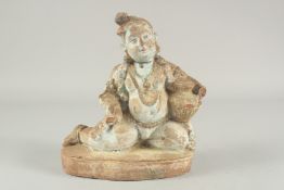 AN UNUSUAL 19TH CENTURY PAINTED TERRACOTTA KRISHNA, 'The Butter Thief', 26cm high, 22cm wide.