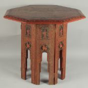 A BURMESE RED AND BLACK LACQUERED WOOD OCTAGONAL TABLE, with hinged folding legs, 65.5cm at widest