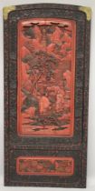 A LARGE 19TH CENTURY CHINESE CARVED BLACK AND RED CINNABAR LACQUER PANEL, depicting two male figures