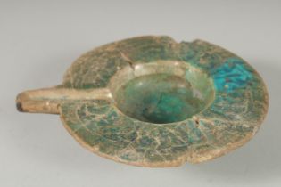 A 12TH-13TH CENTURY PERSIAN KASHAN TURQUOISE GLAZED OIL LAMP, (af), 16cm wide (incl. spout).