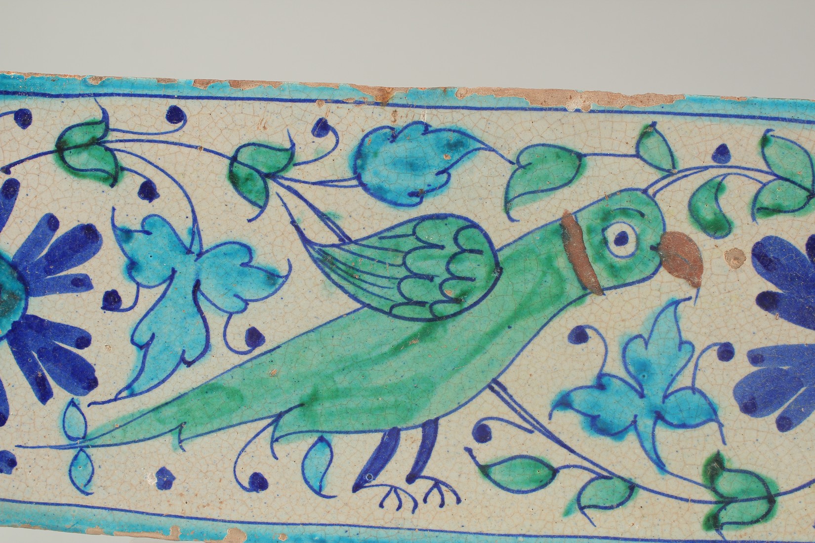 AN EARLY 19TH CENTURY NORTH INDIAN MULTAN GLAZED POTTERY TILE, painted with a parrot, 30.5cm x - Image 2 of 3