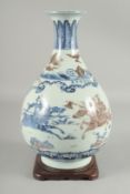 A CHINESE UNDERGLAZE RED AND BLUE PORCELAIN YUHUCHUNPIN VASE, with wooden stand, the vase painted