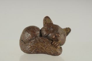 A SMALL JAPANESE BRONZE FIGURE OF A SLEEPING FOX.