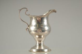 A GEORGE III SILVER CREAM JUG with gadrooned edges. London 1771. Maker: SAMUEL MASSEY/MENTON.