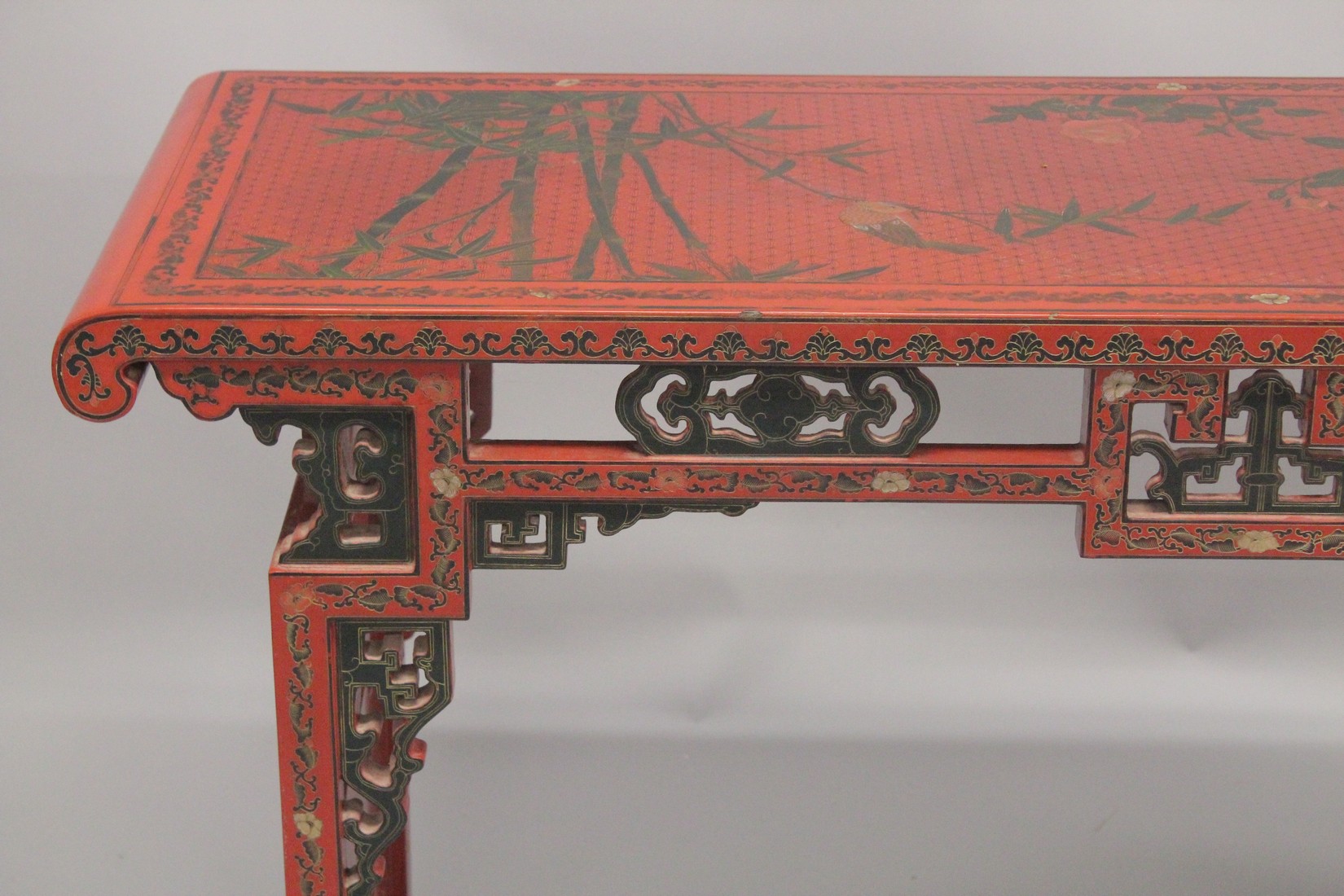 A CHINESE RED LACQUER AND CHINOISERIE DECORATED RECTANGULAR CONSOLE TABLE with a pierced frieze, - Image 2 of 7