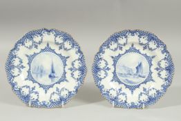 A ROYAL CROWN DERBY PAIR OF PLATES, the centres painted with sailing vessels, by W.E.J. DEAN.