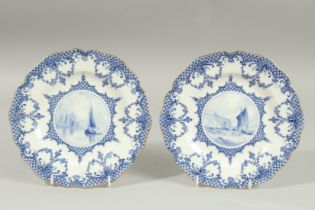A ROYAL CROWN DERBY PAIR OF PLATES, the centres painted with sailing vessels, by W.E.J. DEAN.