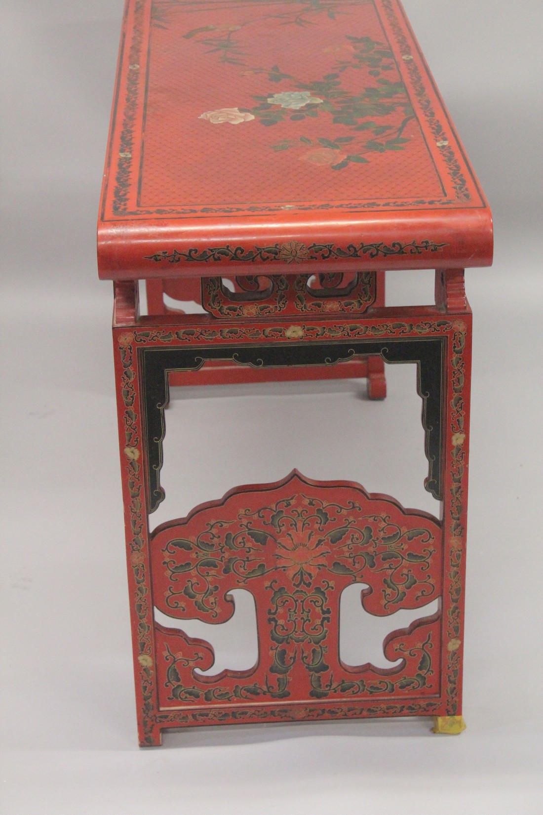 A CHINESE RED LACQUER AND CHINOISERIE DECORATED RECTANGULAR CONSOLE TABLE with a pierced frieze, - Image 7 of 7