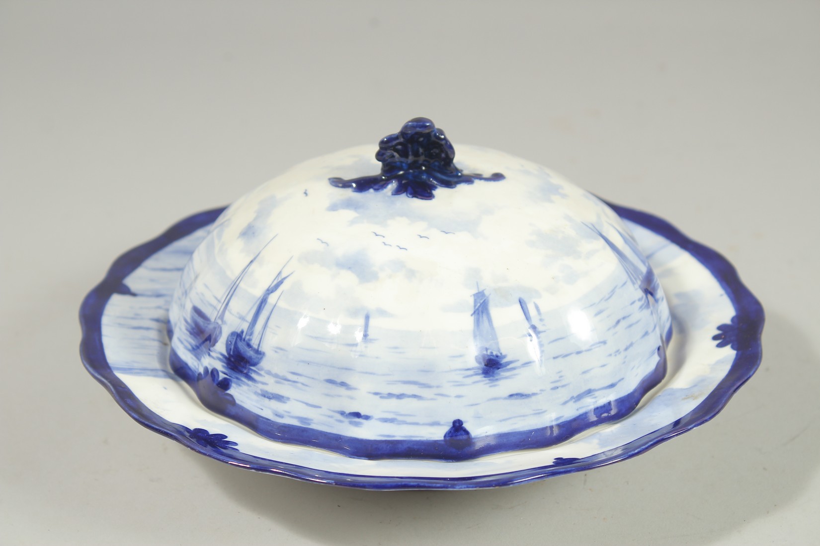 A ROYAL CROWN DERBY MUFFIN DISH AND COVER painted with sailing vessels by W.E.J. DEAN.