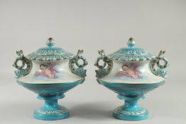 A PAIR OF SEVRES DESIGN LIGHT BLUE CIRCULAR PEDESTAL VASES decorated with cupids. 10ins high.