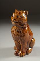 A TREACLE GLAZED CAT MONEY BOX. 5.5ins high.