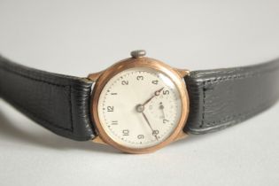 AN OMEGA WRIST WATCH with leather strap.