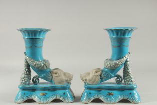 A PAIR OF SEVRES DESIGN BLUE BOARS HEAD CORNUCOPIA VASES. 11ins high.