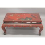 A CHINESE RED LACQUER AND CHINOISERIE DECORATED RECTANGULAR LOW TABLE decorated with flowers,